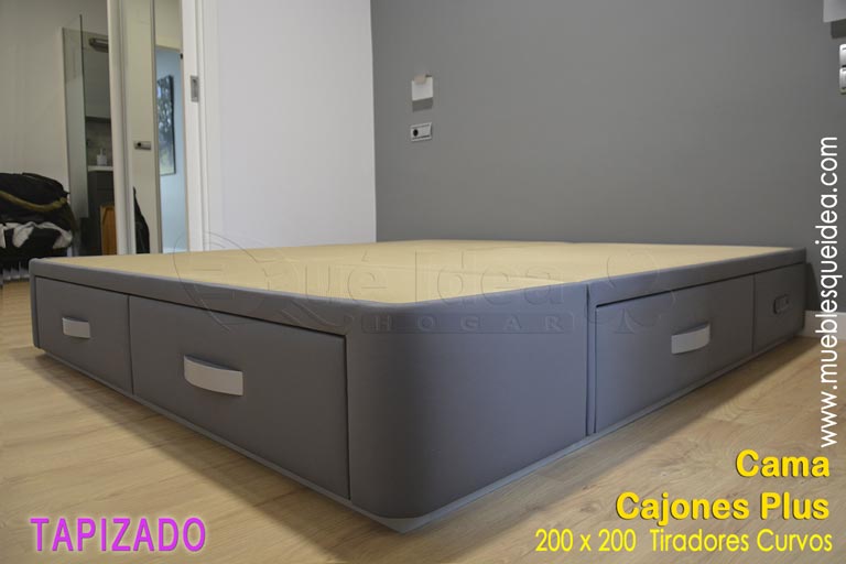 Cama con 6 cajones montada en San Sebastián modelo Plus tapizada en color gris con zócalo y tiradores lacados