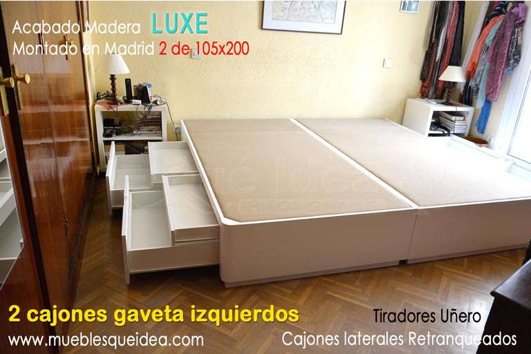 Dos canapés gemelos con cajones dobles gavetas juntos formando una sola cama